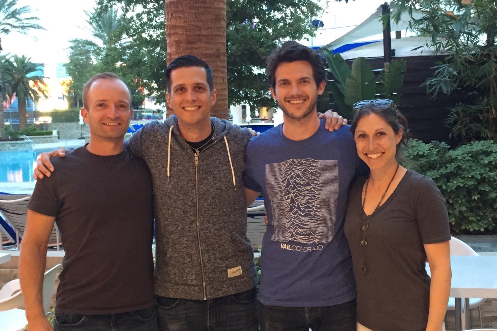 Ken Johnson, Andrew Culver, Matt Goldman, and Joelle Goldman smiling together by a hotel pool at MicroConf in Las Vegas